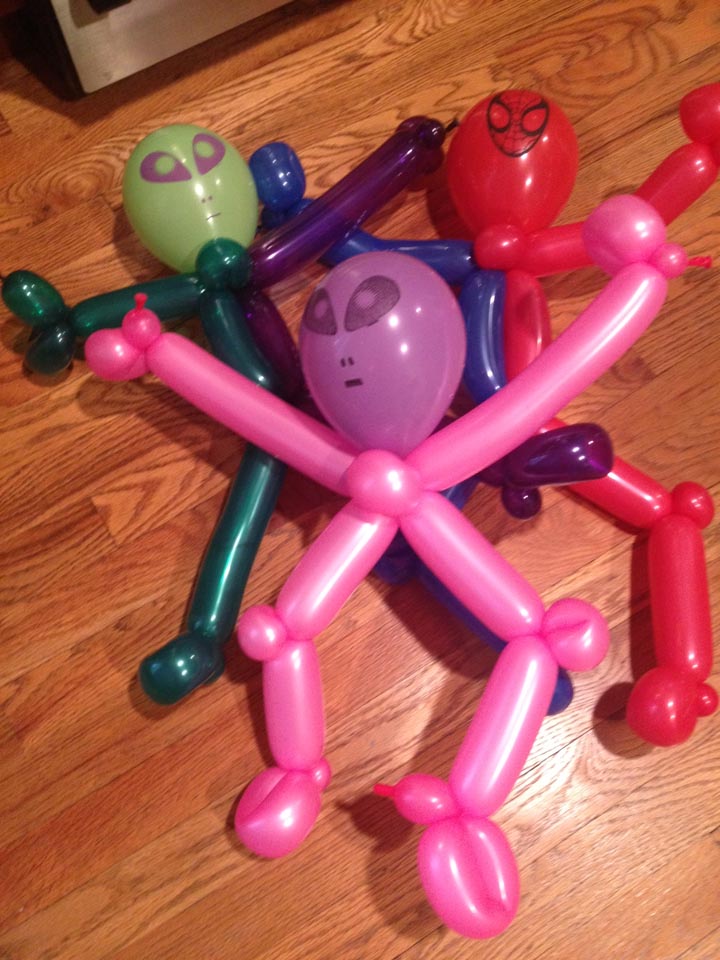 Colorful balloon figures resembling aliens and superheroes