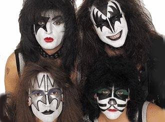 Rock band members in elaborate face paint and costumes