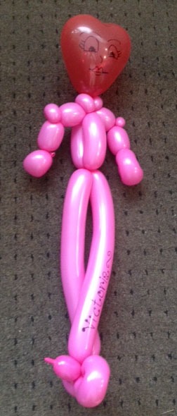 A pink balloon figure resembling a person