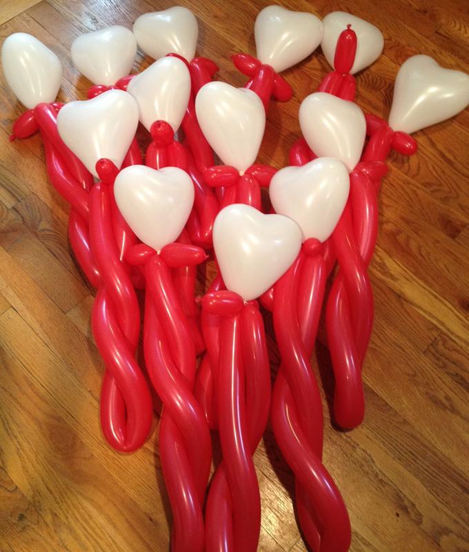 A cluster of red and white balloon creations resembling heart-shaped balloons