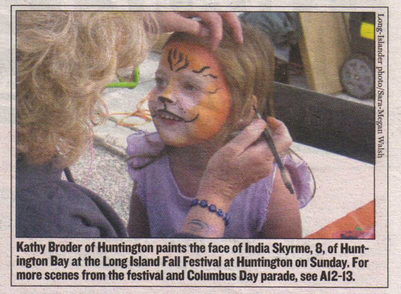 Kathy Broder paints a tiger design on India Skyrme's face