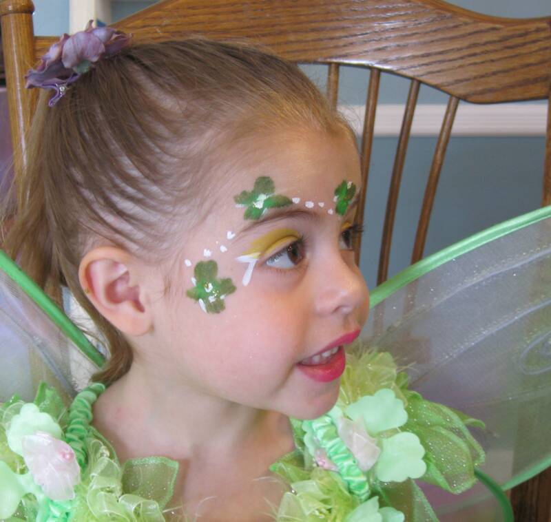 Young girl dressed as a fairy with vibrant green wings