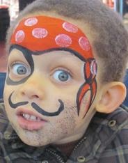 A young boy with face paint resembling a pirate