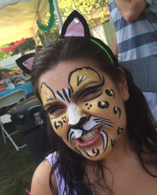 Child with face paint resembling a leopard